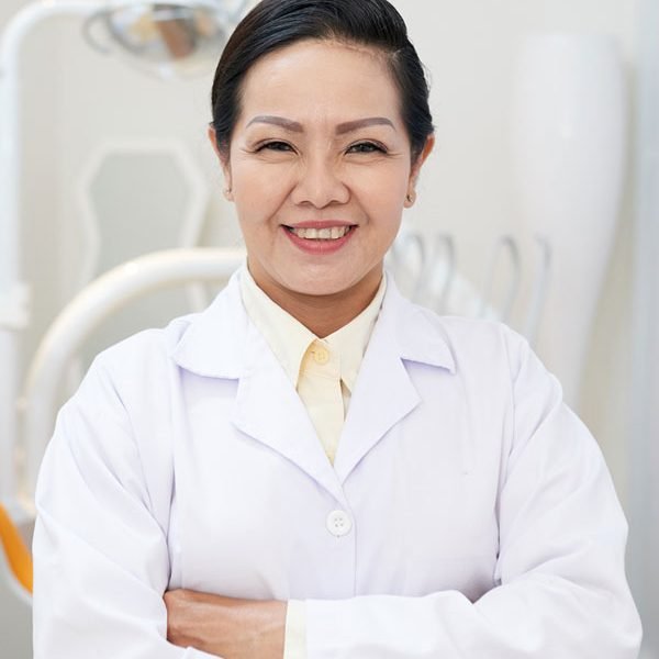 cheerful-ethnic-dentist-in-white-gown-NX8F3SB.jpg