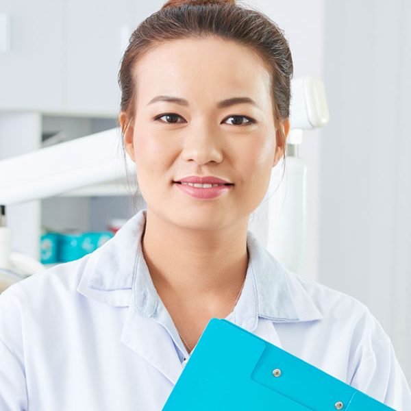 dentist-with-clipboard-portrait-93HAWYC.jpg